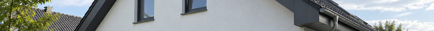 Einfamilienhaus mit Ortgang und Dachkasten, verkleidet mit anthrazitfarbenen Aluverbundplatten – Deutsche Kunststoffbedachungen